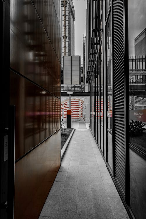 A Narrow Passage between the Walls of a Modern Building in City 