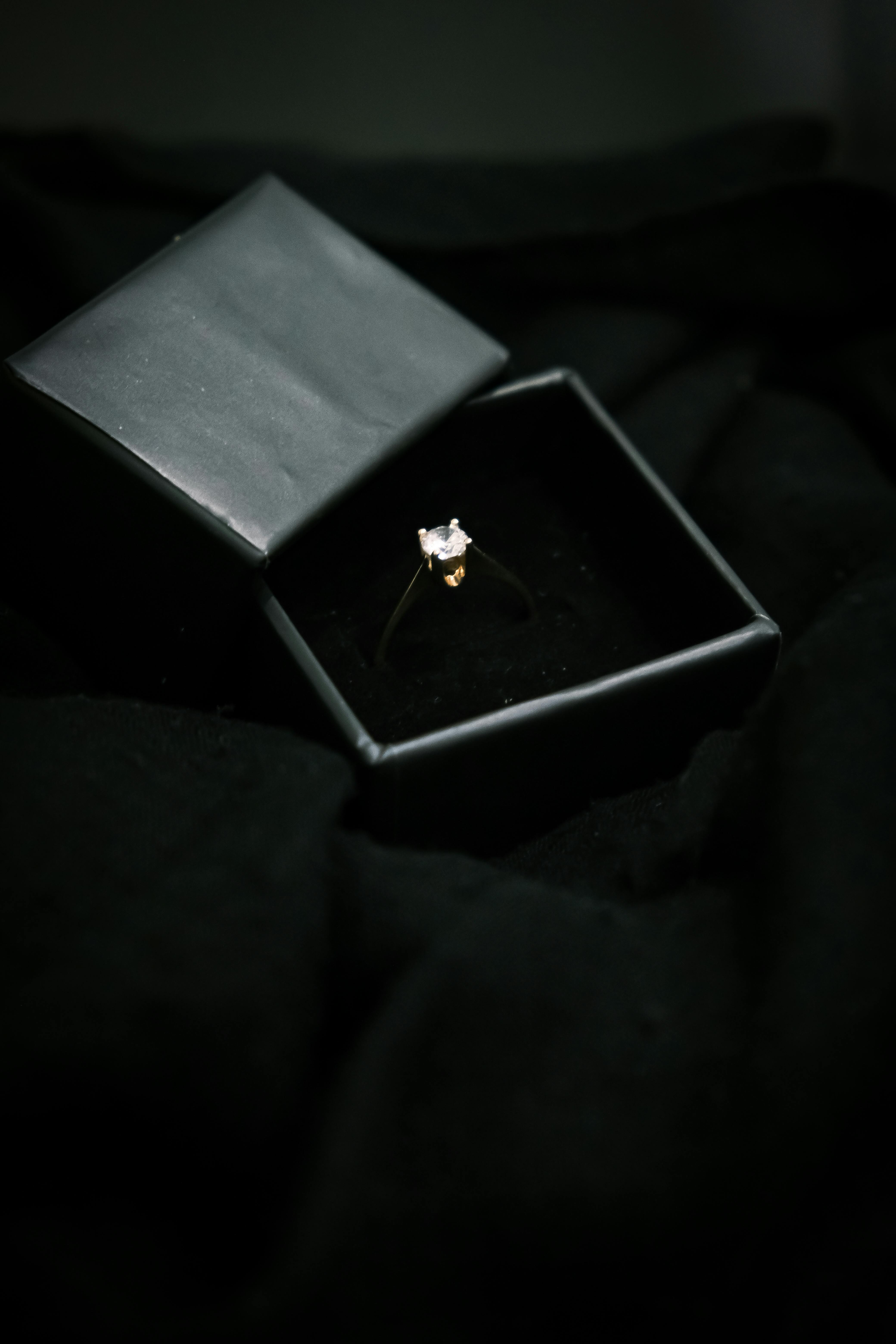 Premium Photo | Diamond wedding ring in the box on wooden table.