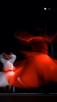 Artistic capture of whirling dervishes in vibrant motion blur, Burdur, Türkiye.