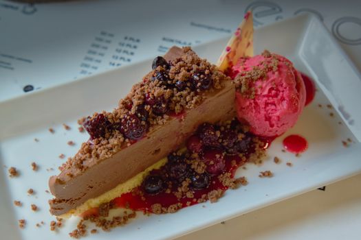 Scrumptious chocolate mousse topped with berries and a scoop of raspberry sorbet.