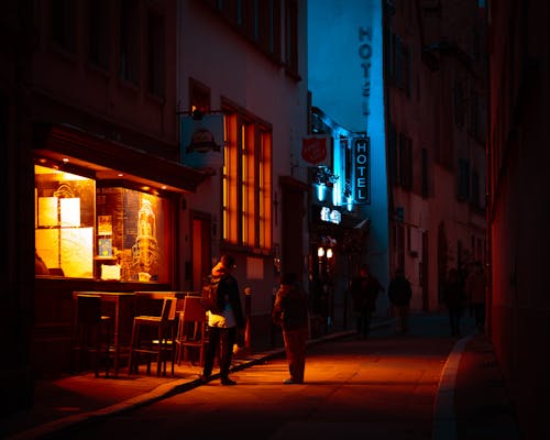 People Standing on a City Street at Night