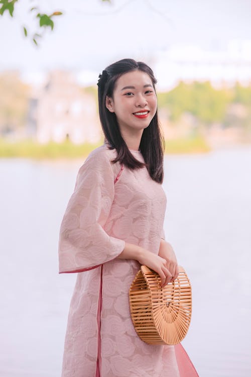 Smiling Woman with Bag and in Traditional Clothing