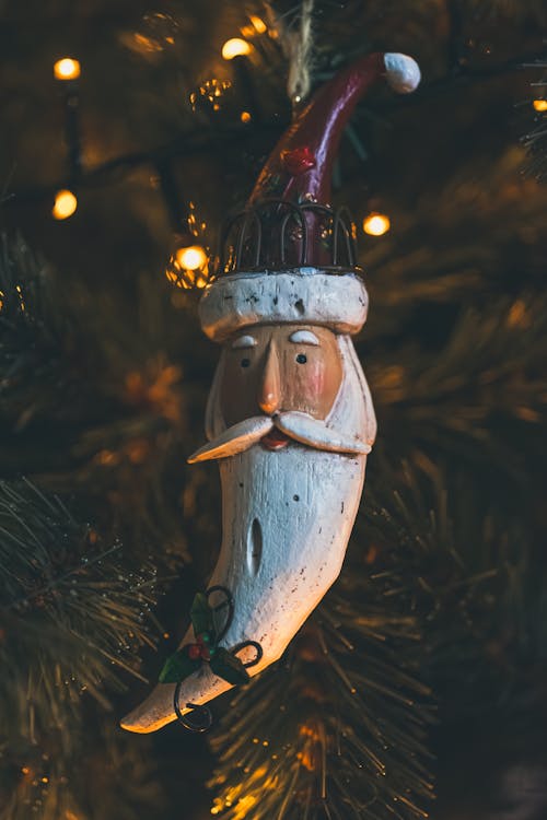 Santa Claus Shaped Decoration Hanging on a Christmas Tree