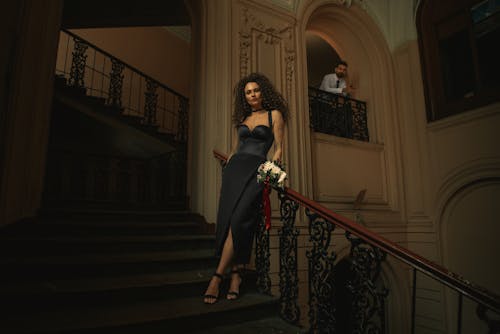 Woman in Dress Standing on Stairs