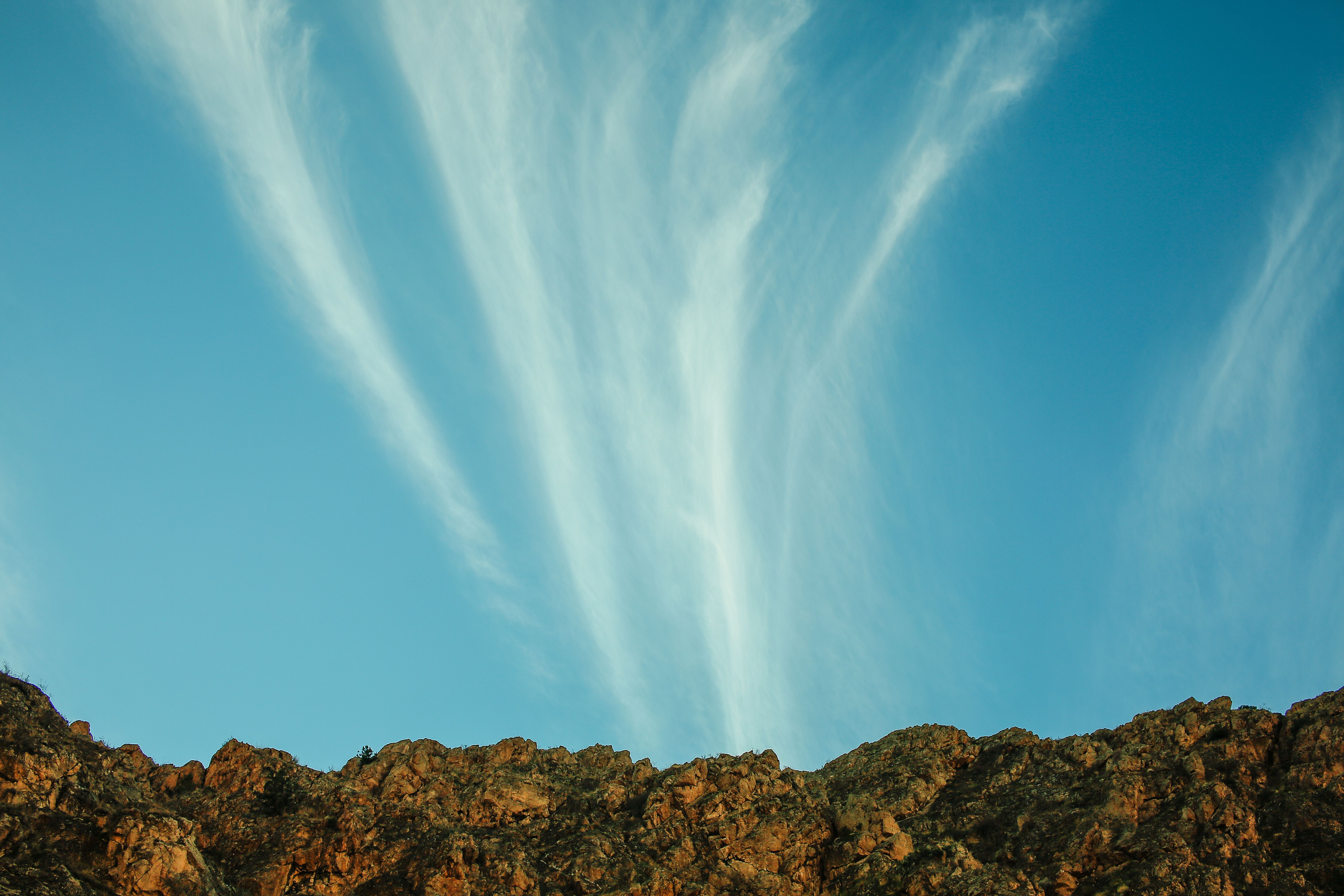 Cloud on Blue Sky over Rocks · Free Stock Photo