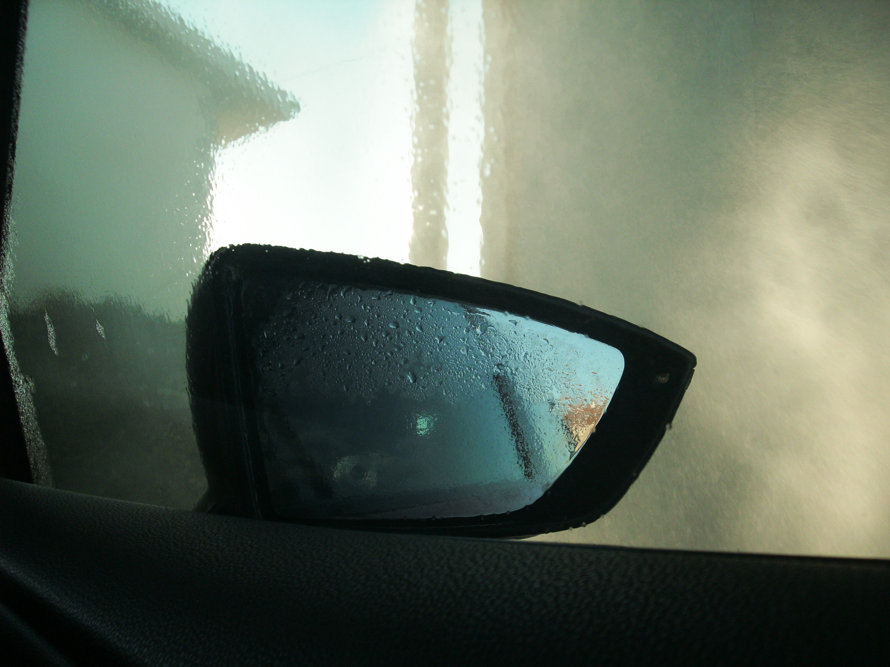 Bathroom mirror covered with fog and water condensation droplets
