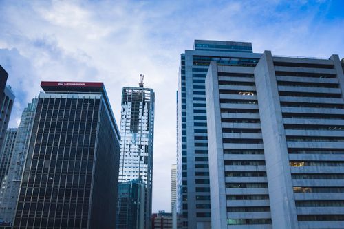 Free Tall skyscrapers dominate the urban skyline, showcasing modern architectural designs in twilight. Stock Photo