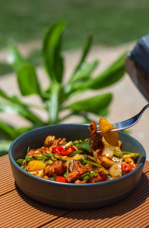 Free Colorful stir-fry in a bowl featuring fried vegetables, peppers, and nuts, highlighting a balanced meal. Stock Photo