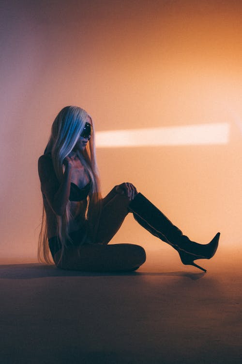Woman in a Thigh High Boots and Bra Sitting on the Floor 