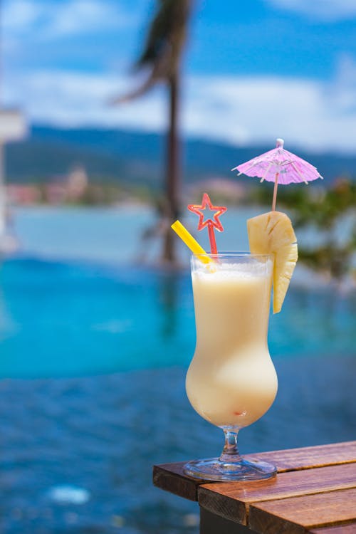 Yellow Cocktail against a Blue Swimming Pool