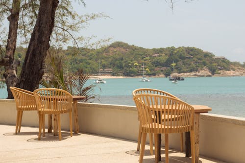 Wooden Chairs on a Terrace by the Sea