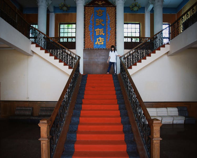 Symmetrical View Of A University Hall With A Staircase