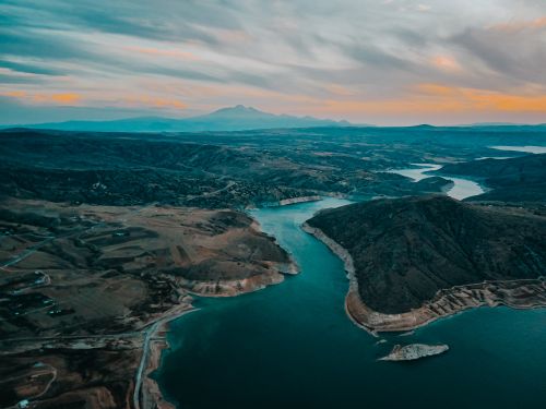 Free Breathtaking aerial view of Felahiye, Kayseri showcasing tranquil waterways and hills at dusk. Stock Photo