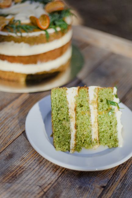 A close-up of a green tea layered cake slice on a wooden table, perfect dessert treat.