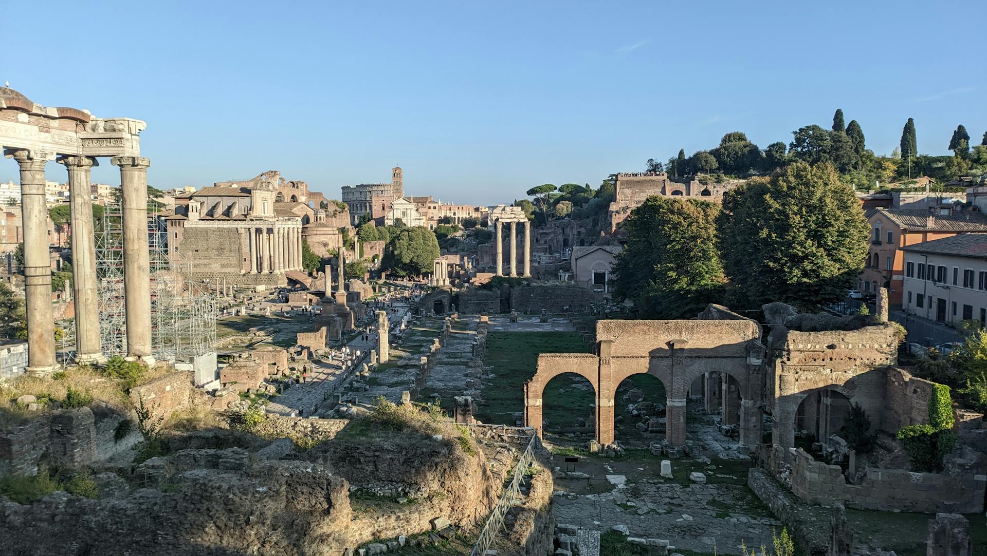 Explore the historic Roman Forum ruins in Rome during a serene sunset, a must-see travel destination.