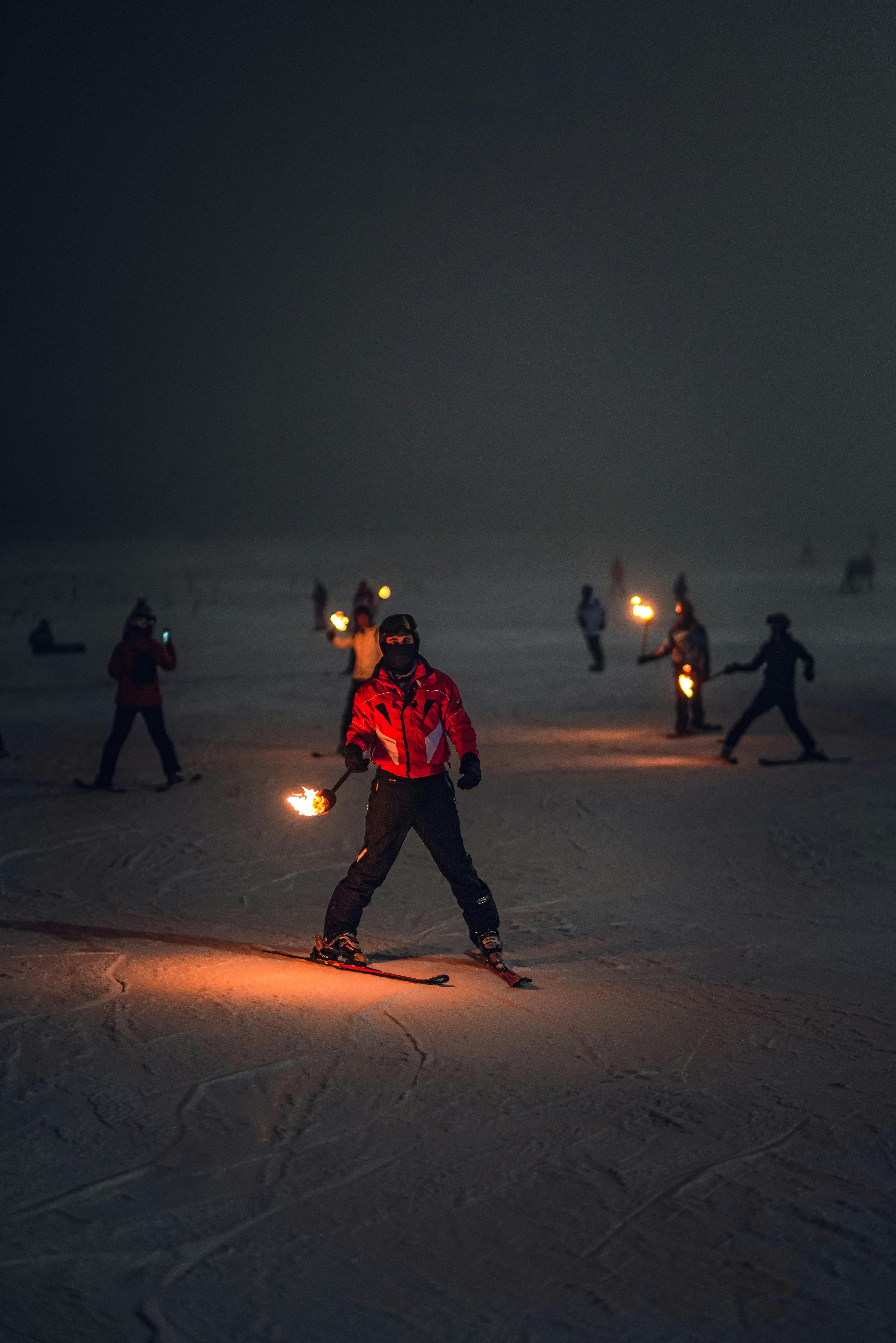 People Skiing at Night with Burning Torches in Hands · Free Stock Photo