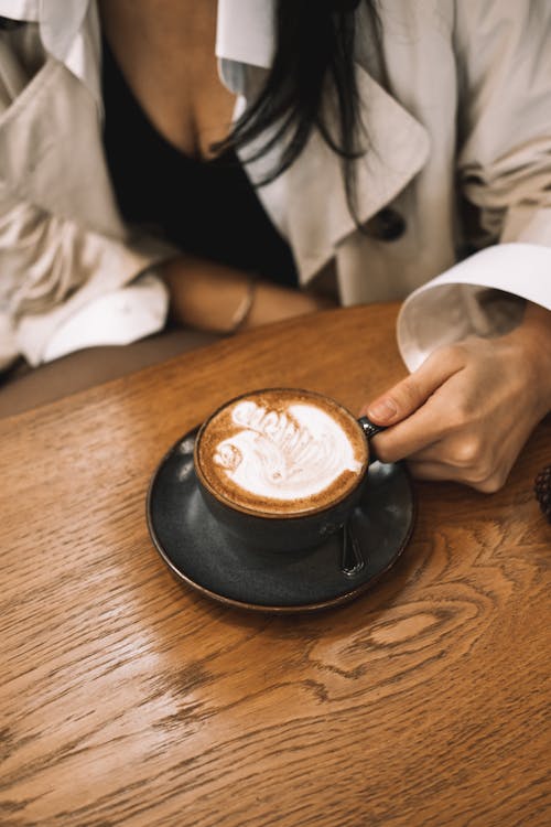 Woman Drinking Milk Coffee in a Coffee Shop 