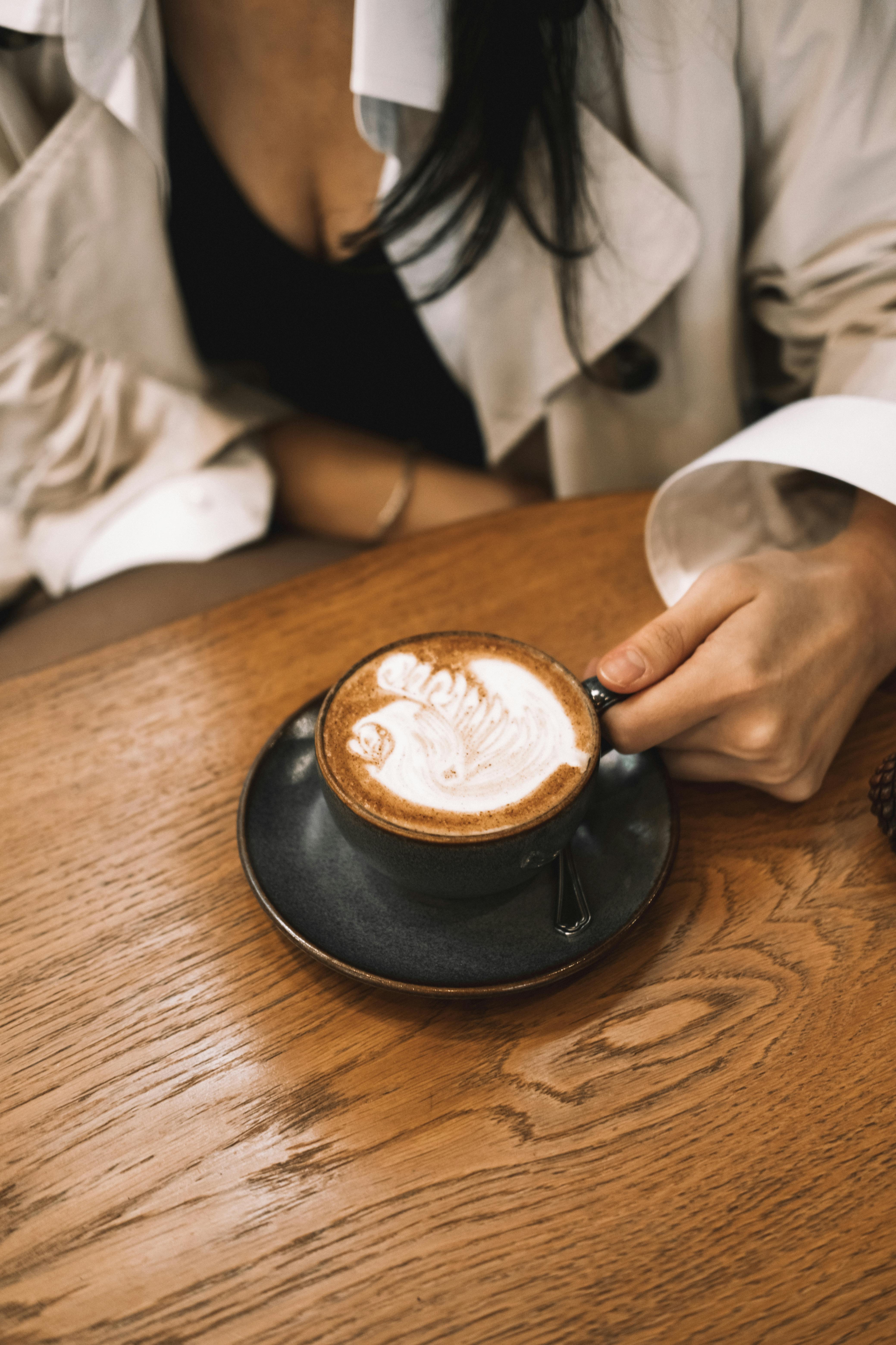 Woman Drinking Milk Coffee in a Coffee Shop · Free Stock Photo