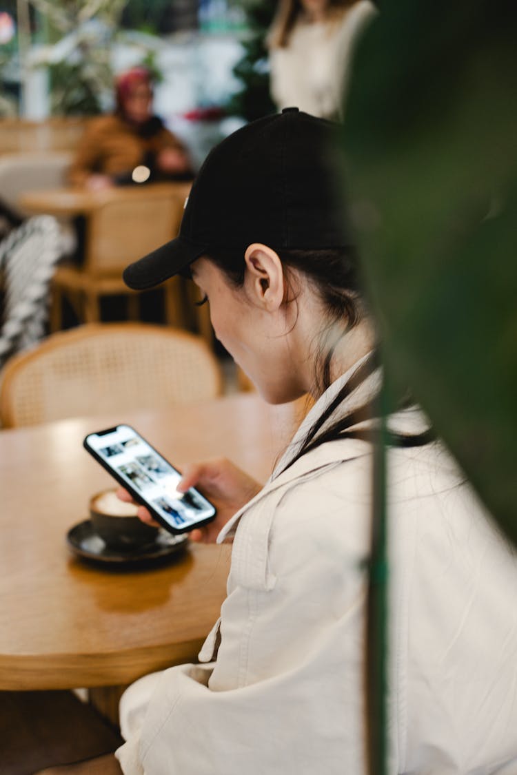 Woman Checking Phone In A Restaurant