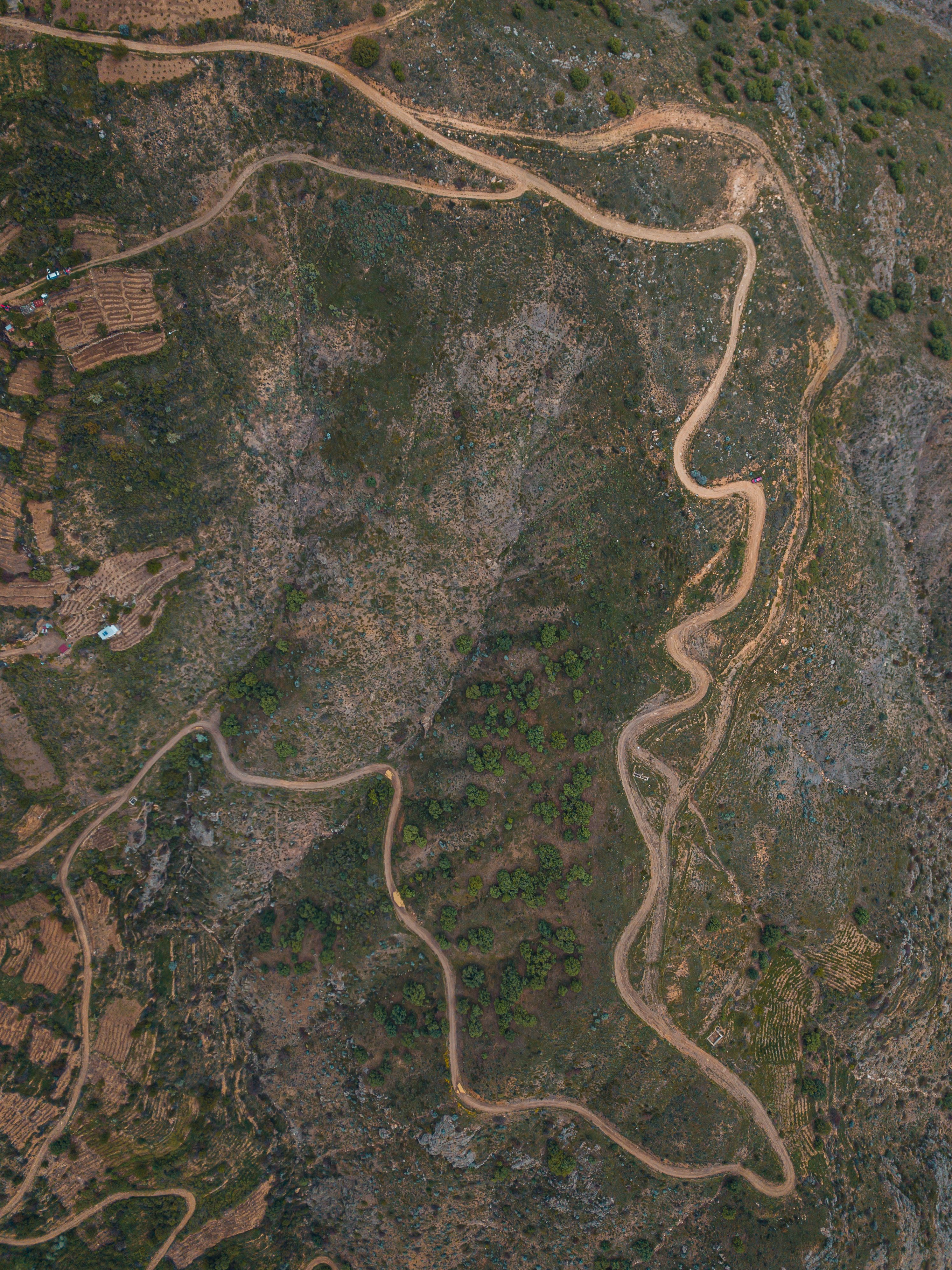 Explore a scenic aerial view of a winding rural road through the hills of Felahiye, Kayseri, Türkiye.