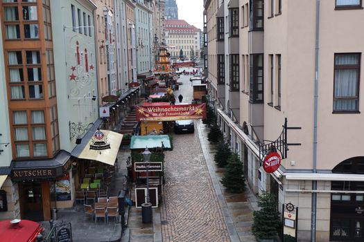A vibrant Christmas market scene in Dresden, showcasing traditional stalls and festive decorations.