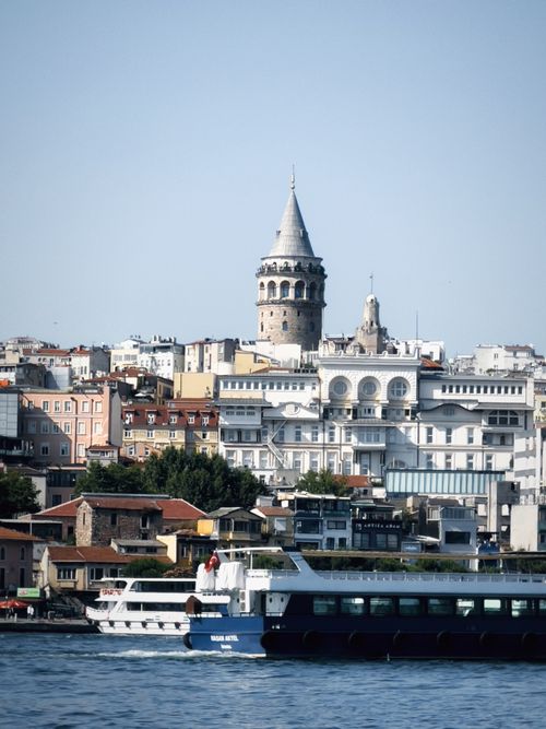 Free Scenic view of Galata Tower with a ferry on the Bosphorus in Istanbul, Turkey. Stock Photo