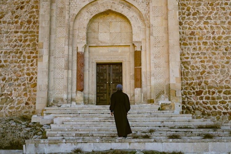 Woman Standing On Stairs Of Vintage Building