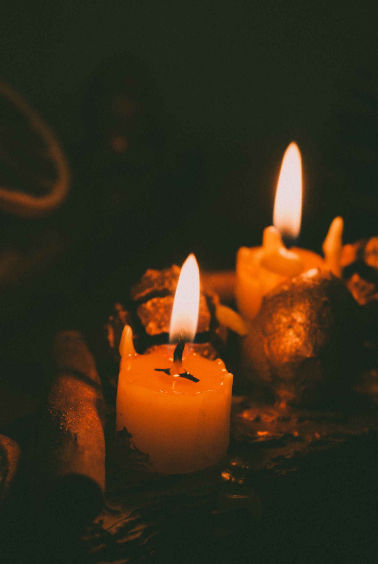 Candles burning softly in the dark for a seasonal ritual