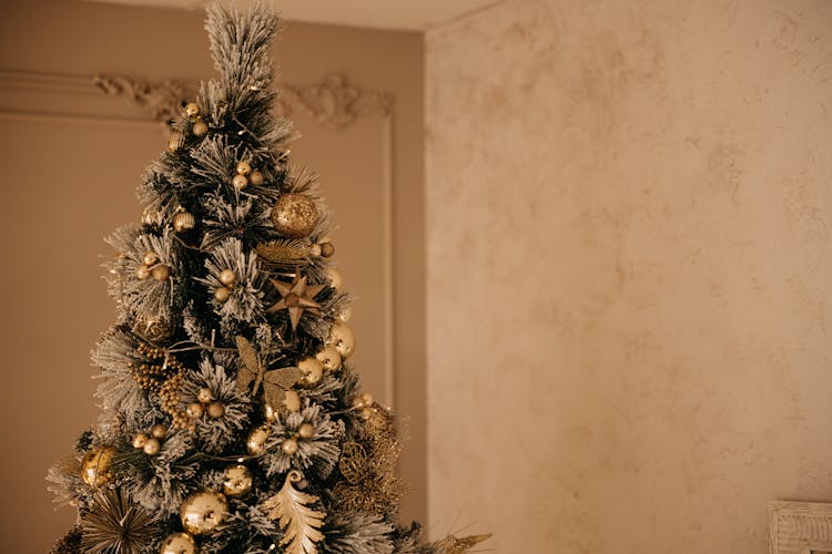 A Christmas Tree With Golden Ornaments 