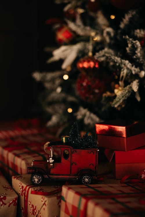 Close-up of a Christmas Decoration Standing on Presents under a Christmas Tree