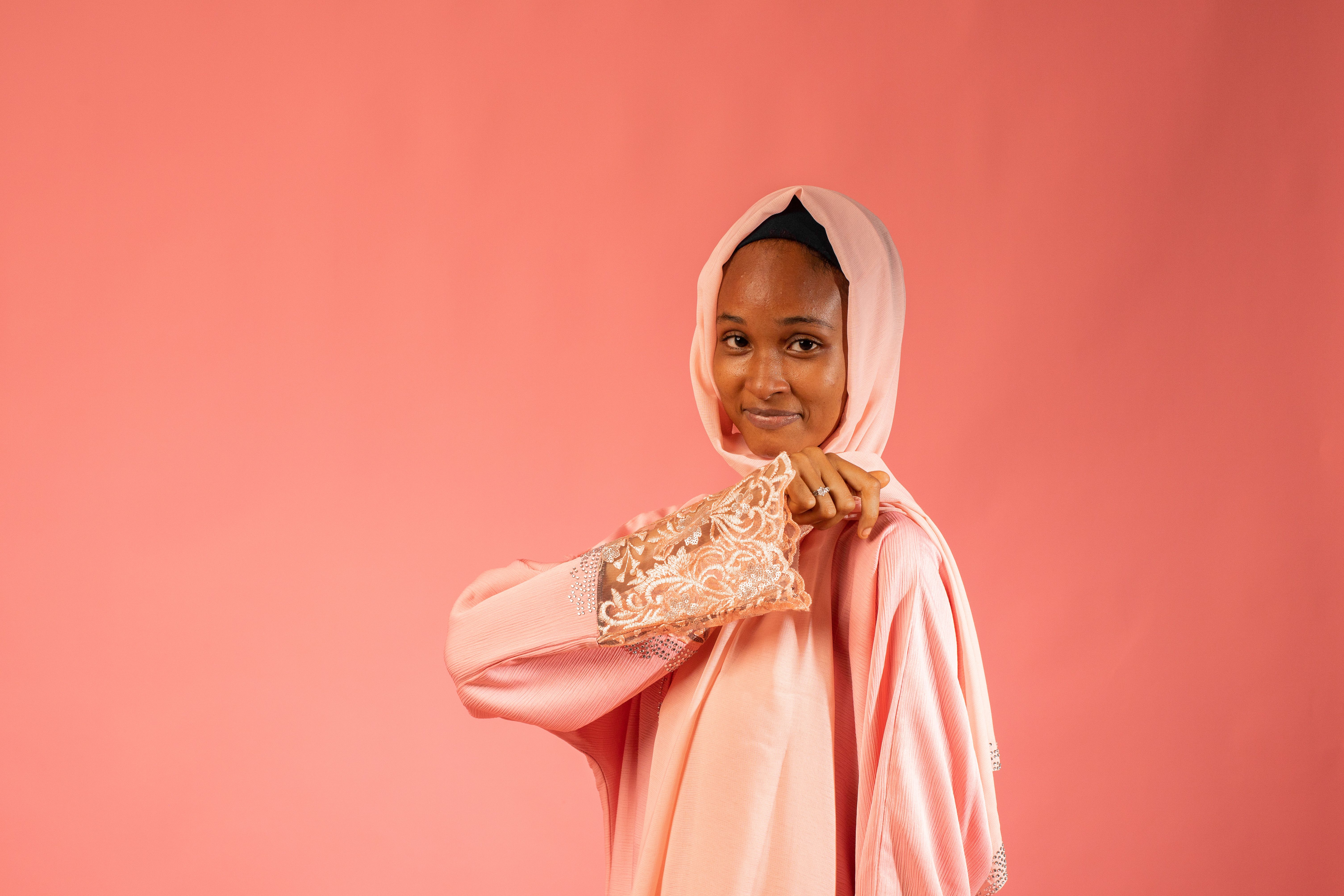 Portrait of Woman Wearing Traditional Pink Headscarf · Free Stock Photo