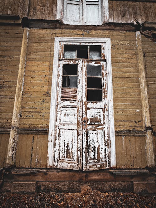 Broken Windows in Door of Abandoned House
