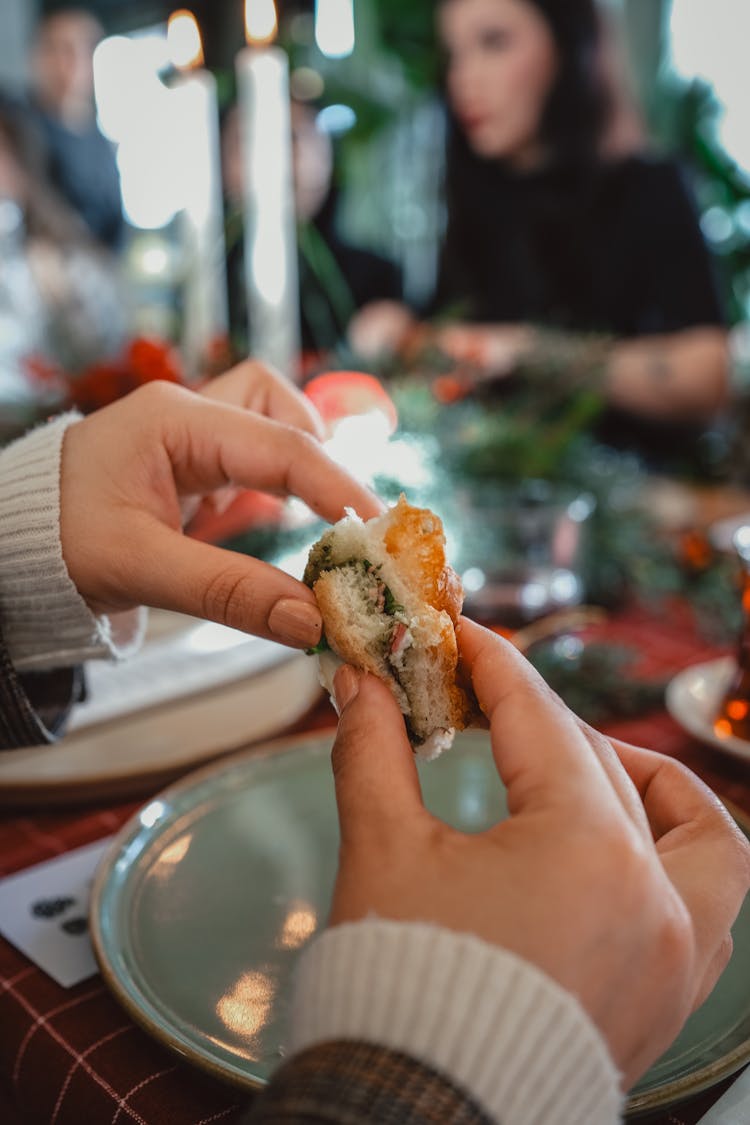 Person Eating Food In A Restaurant