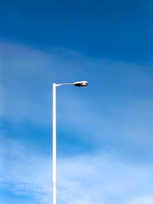 Free A minimalist view of a street lamp against a clear blue sky in Penn Yan, NY. Stock Photo