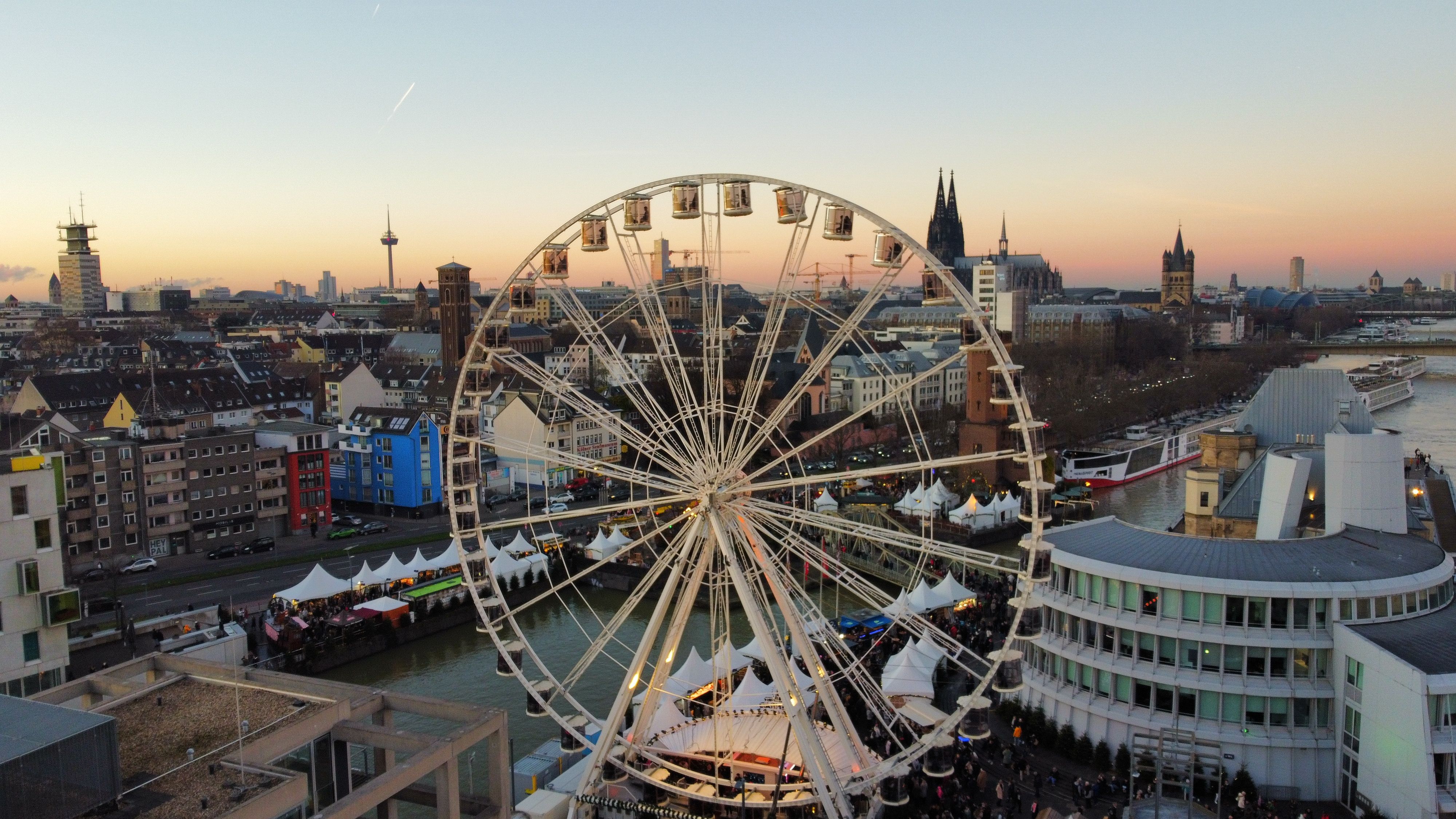 Aerial View of a Ferris Wheel and the City at Sunset · Free Stock Photo