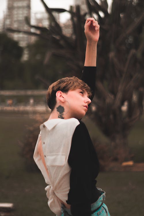 Free Selective Focus Photography of Woman Near Trees Stock Photo