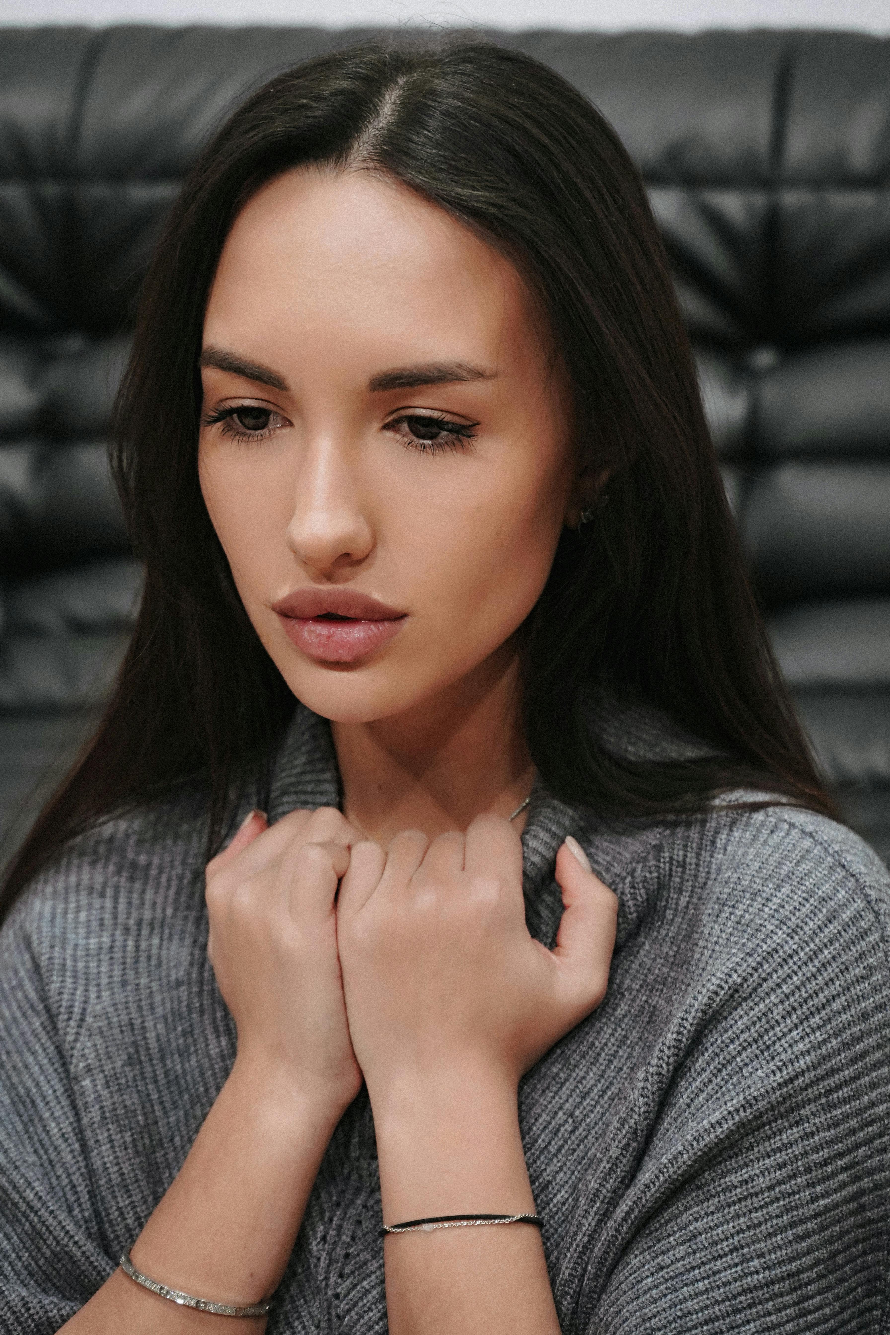 woman pulling on the turtleneck of her sweater