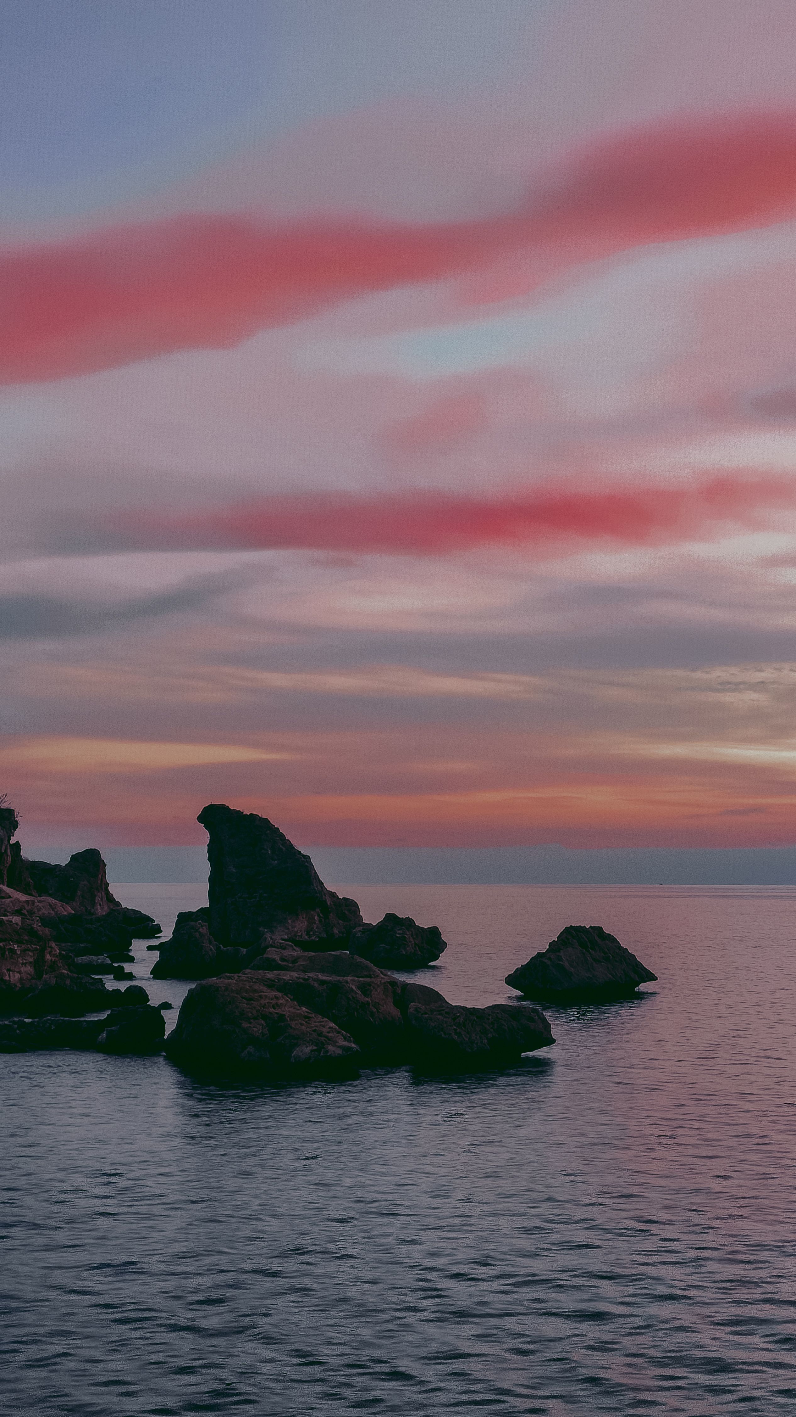 A breathtaking view of eroded rocks on the Antalya coast during a vibrant sunset.
