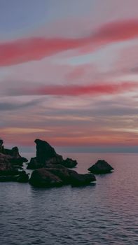 A breathtaking view of eroded rocks on the Antalya coast during a vibrant sunset.