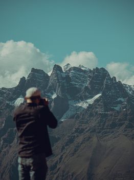 Silhouette of a photographer capturing the majestic snowcapped Andes in Peru.