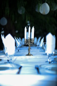 Beautifully arranged dining table with candlestick, glasses, and napkins in Provence, France.