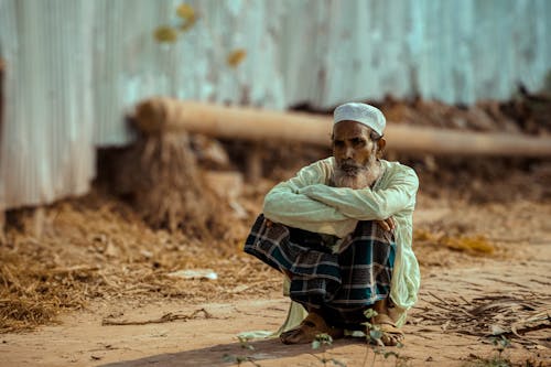 Elderly Man Sitting with Arms Crossed