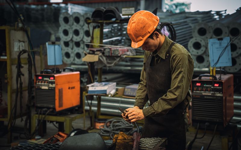 Factory worker operating plant machinery