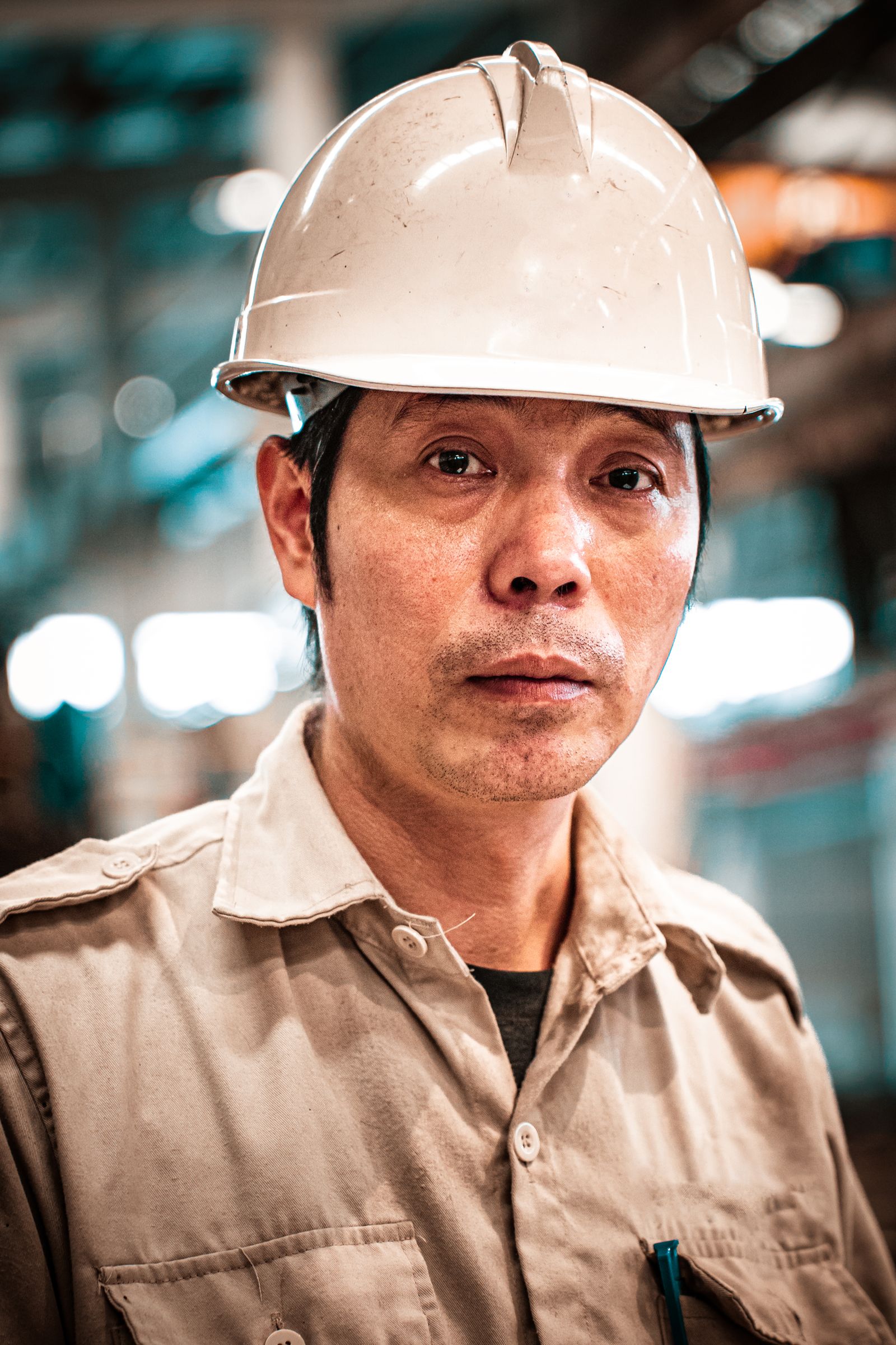 Industrial worker wearing a hard hat inside a warehouse