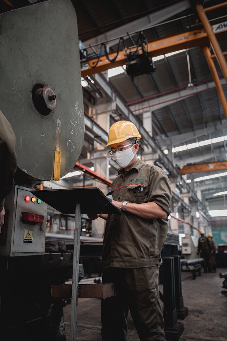 Factory Worker Reading The Manual