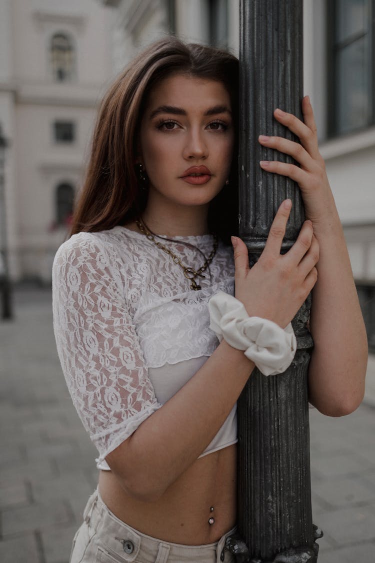 Woman Posing In White Outfit On A Street