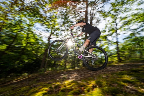 Man Riding a Mountain Bike through the Forest 