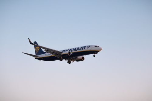 Free A Ryanair Boeing airplane flying during daytime with a clear blue sky backdrop. Stock Photo