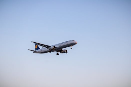 Passenger airplane in flight against blue sky, showcasing air travel and aviation technology.