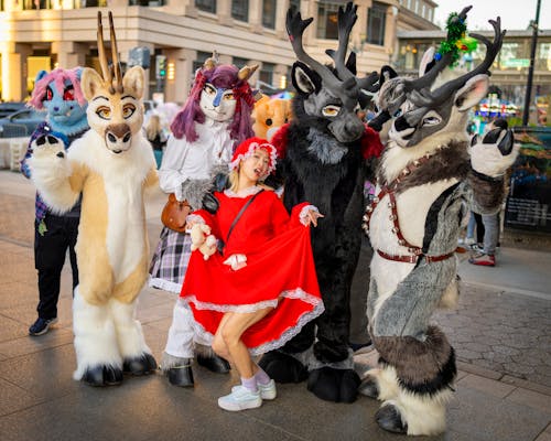 Group of People in Costumes Posing in a Town Square 